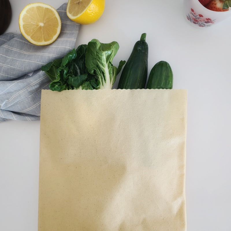 Natural cotton beeswax produce bag with herbs and vegetables.