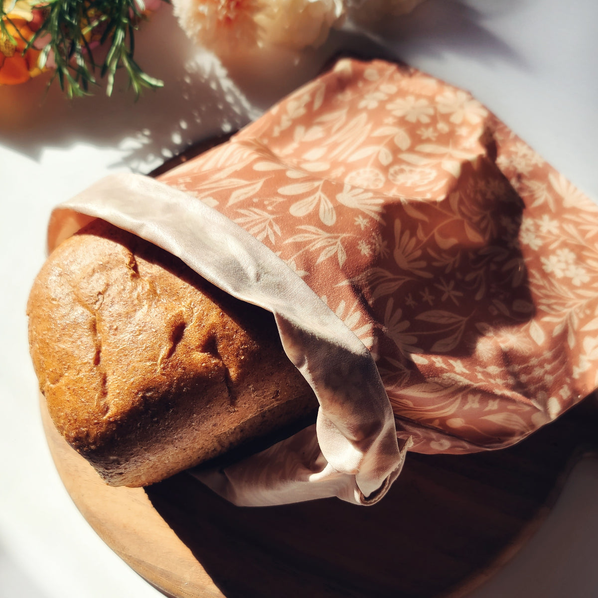 Loaf of bread in a reusable beeswax bread bag.