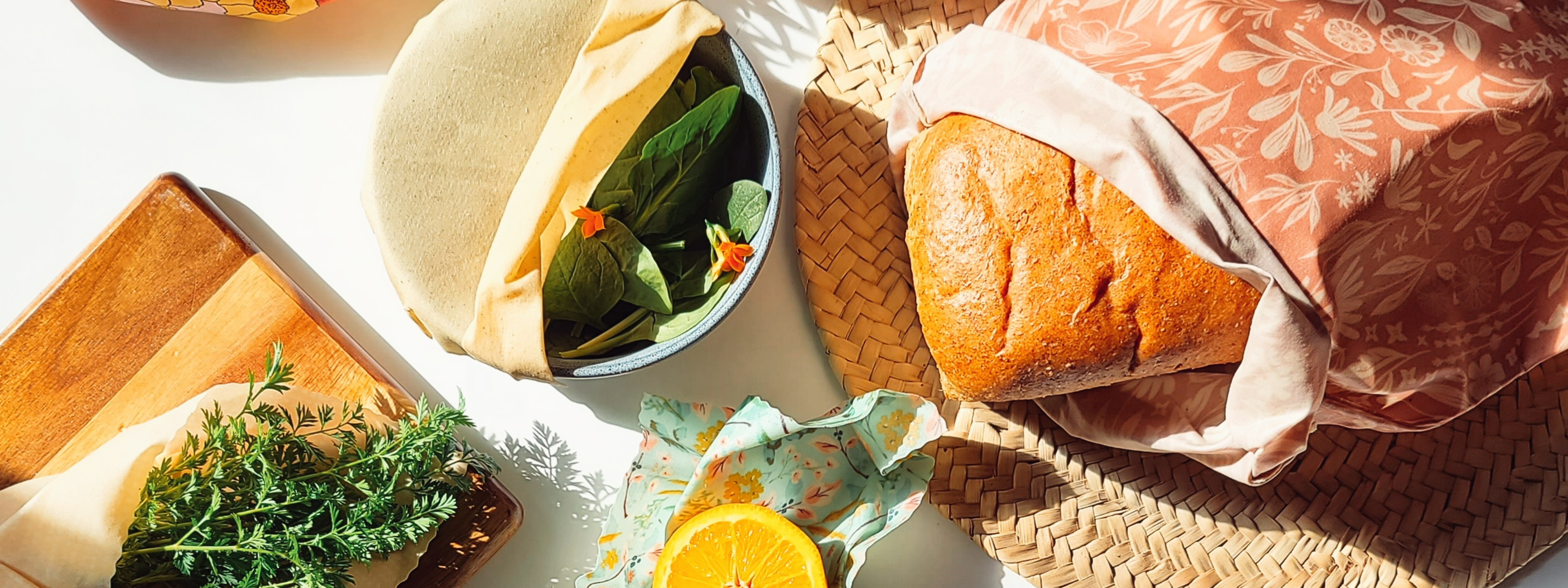 Bread and fruit wrapped in beeswax reusable food wrap.