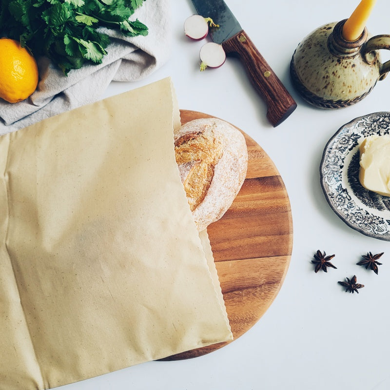 reusable beeswax bread bag with fresh baked loaf